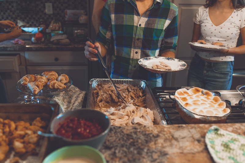 person picking food on tray